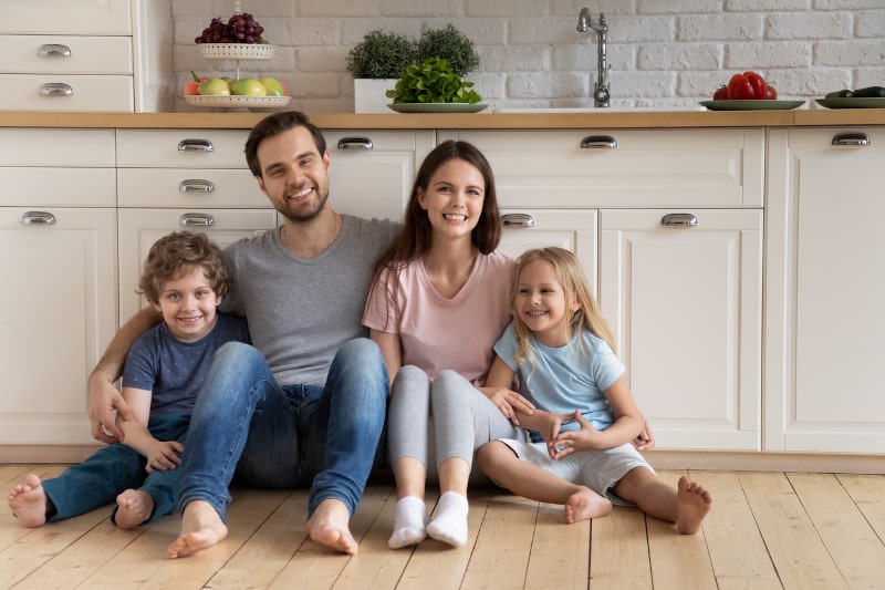 Smiling Family On Kitchen Floor Smiling Family On Kitchen Floor